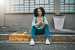 Black woman, city sidewalk and smartphone in hand scroll social media smile sitting on the street pavement. Happy woman, texting on phone and using 5g mobile network for outdoor online communication 