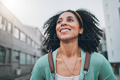 Buy stock photo Black woman, city travel and smile with exchange student holding backpack and feel happy  looking at buildings and walking down street. Female, motivation and vision for urban opportunity in London
