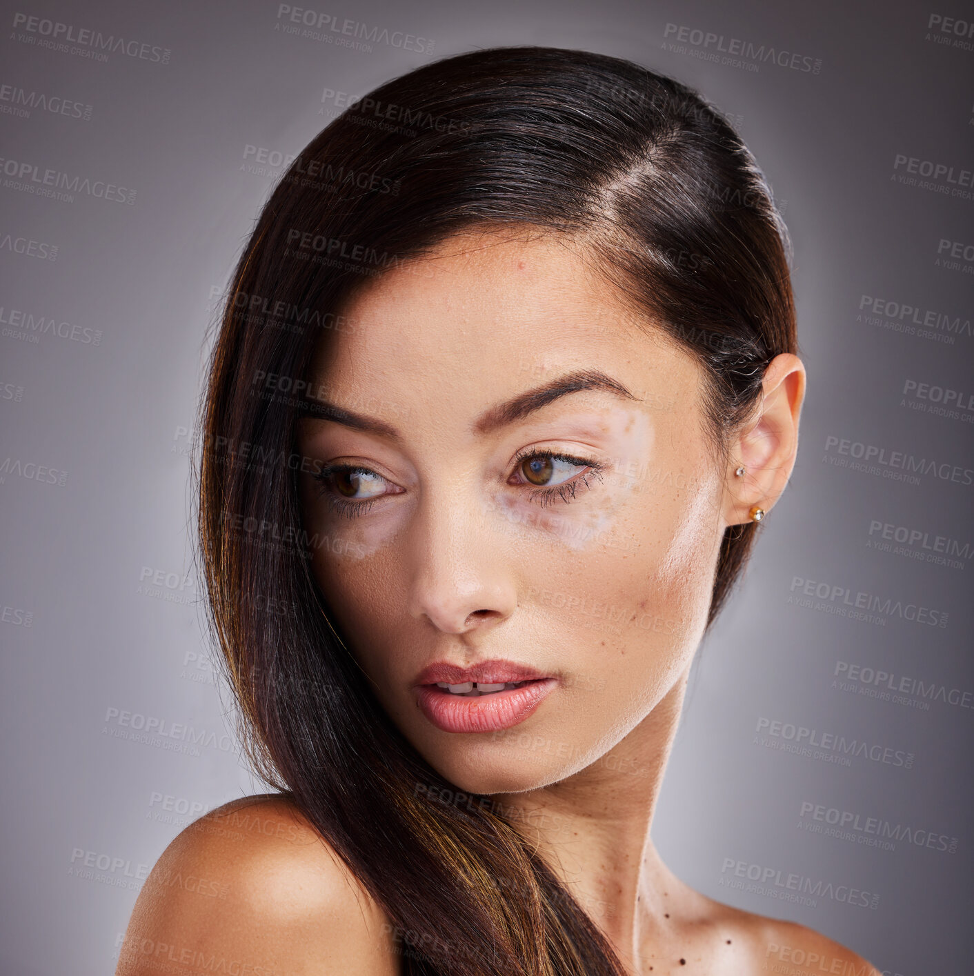 Buy stock photo Beauty, face and vitiligo with a model woman in studio on a gray background for natural hair care. Wellness, luxury and cosmetics with a young female posing for dermatology, wellness or pigmentation