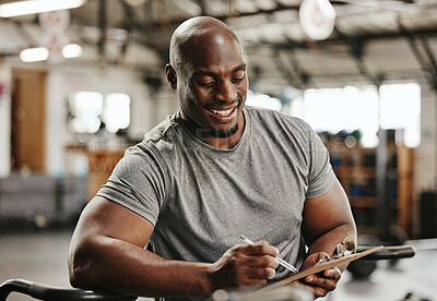 Buy stock photo Gym, workout and personal trainer with checklist on clipboard consulting for training sports in gym. Black man of muscular, active and smiling fitness coach writing on health, wellness and exercise
