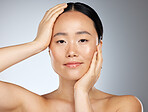 Skincare, beauty and woman with facial makeup against a grey mockup studio background. Face portrait of a happy, relax and calm Asian model with peace from cosmetics, dermatology and skin wellness