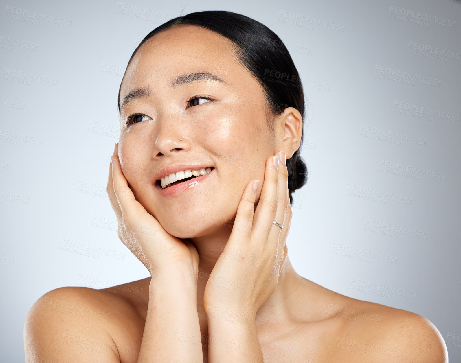 Buy stock photo Asian woman, face glow and skincare routine with hands touching cheeks on grey studio background. Smile, happy or beauty model in healthy wellness, relax self love dermatology or hydrated skin facial