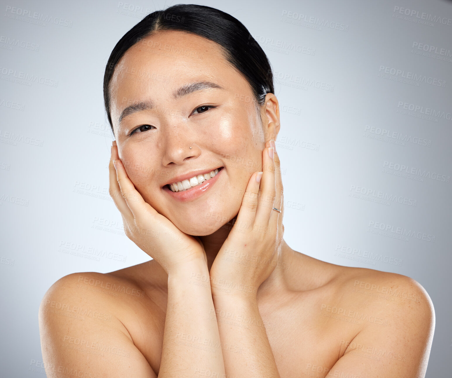 Buy stock photo Asian, woman and skincare with hands on face for beauty, cosmetics and makeup with grey background. Model, skin and smile with cosmetic, self care and dermatology for health, wellness and studio wall
