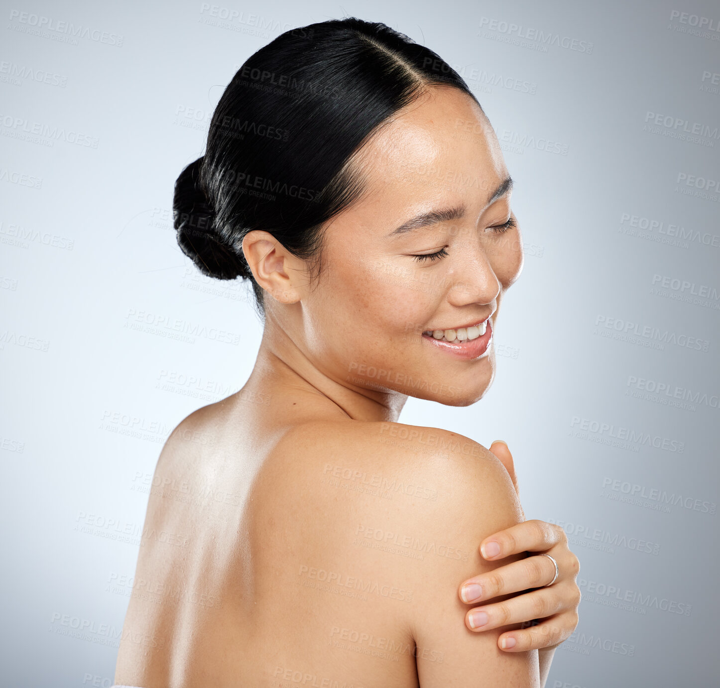 Buy stock photo Skincare, beauty and body care with a model asian woman in studio on a gray background for natural wellness. Cosmetic, treatment and skin care with an attractive woman posing to promote a product