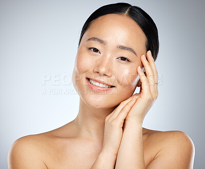 Buy stock photo Face, beauty skicare and asian woman with makeup, cosmetics and skin health or wellness . Portrait healthy girl smile in studio against a grey background and routine for soft, smooth or glowing skin