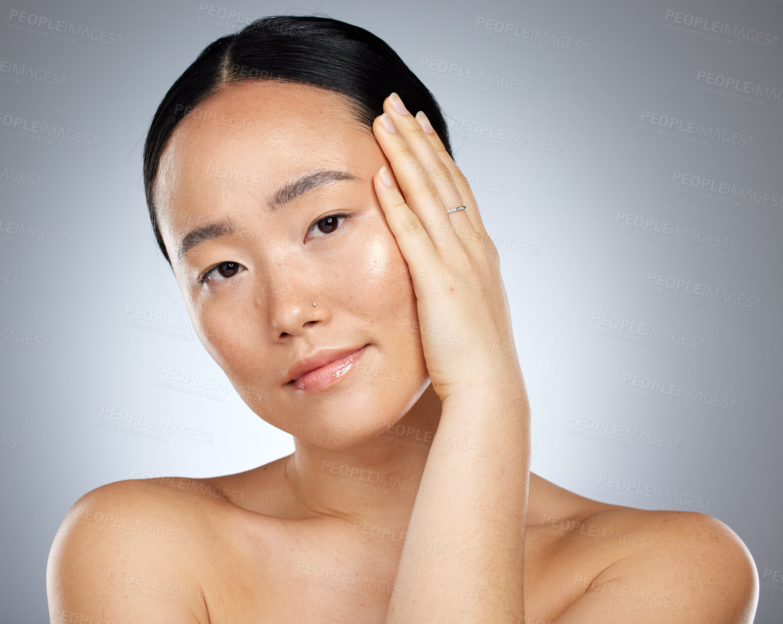 Buy stock photo Beauty, skincare and Asian woman with hand on face on gray studio background. Wellness, health or facial cosmetics, luxury makeup and female model from Singapore with glowing, healthy or perfect skin