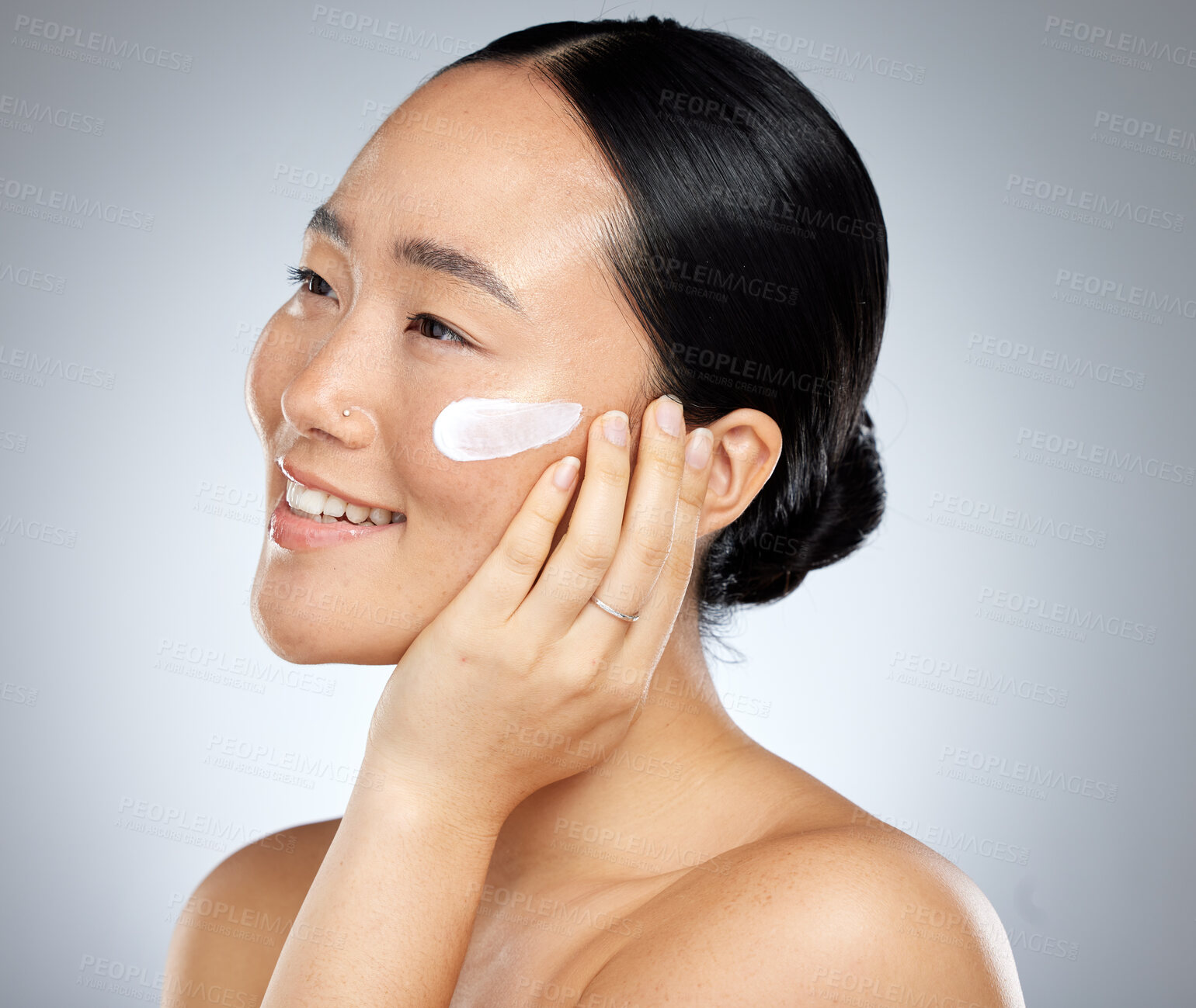 Buy stock photo Beauty, face and skincare cream with woman in a studio for facial, cleaning and grooming with mockup. Skin, sunscreen and asian model relax with wellness product, cosmetics and face cream treatment 