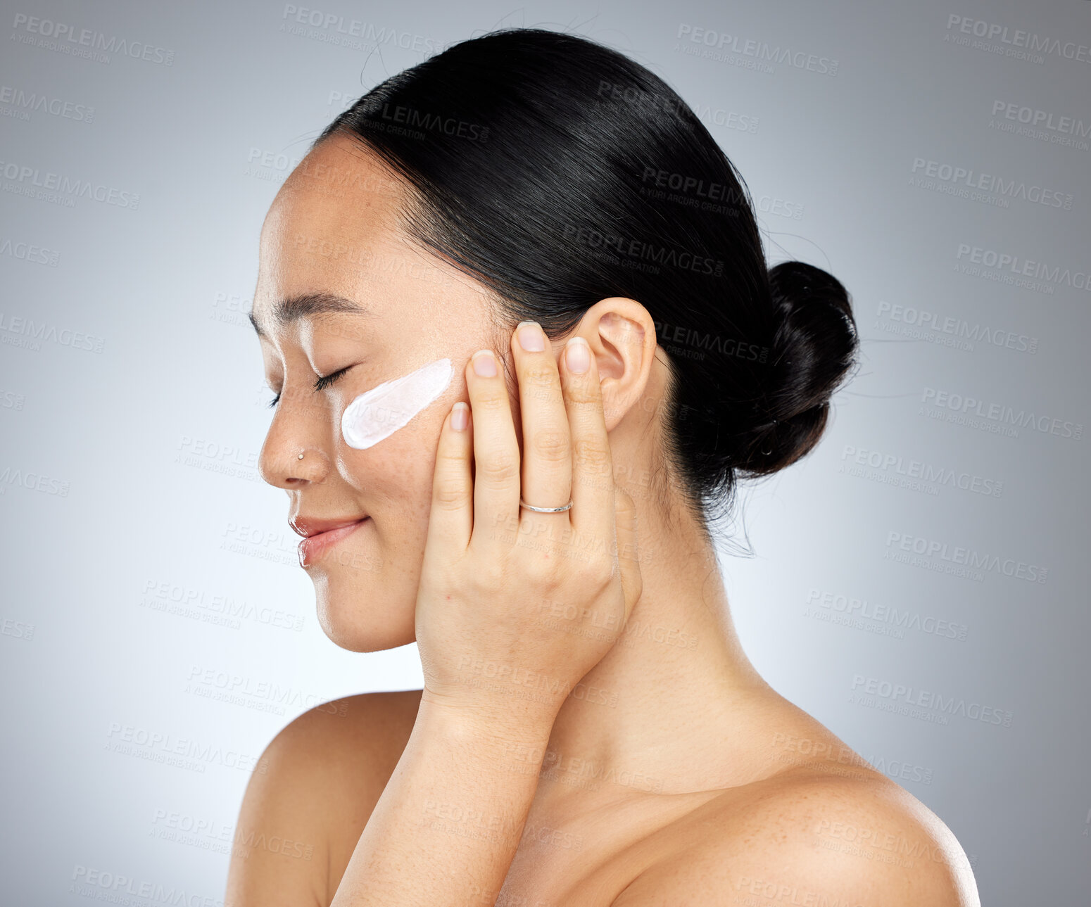 Buy stock photo Beauty, skin and woman, cream and natural cosmetic advertising for face, moisturizing product and skincare with grey studio background. Asian model, facial treatment and body care, fresh and glow.
