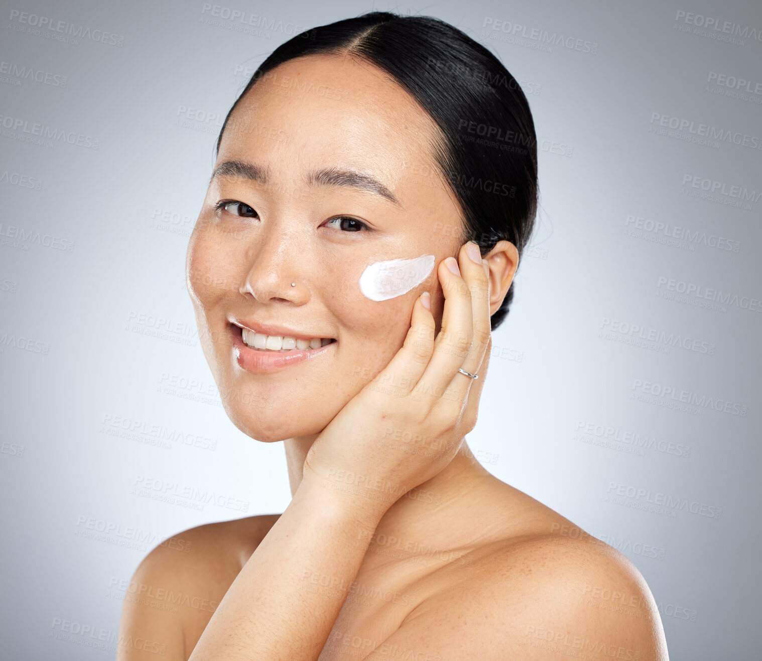Buy stock photo Woman, face cream or grooming skincare routine on studio background for Japanese facial, wellness or luxury healthcare. Zoom, smile or happy beauty model with spf sunscreen product for sun protection
