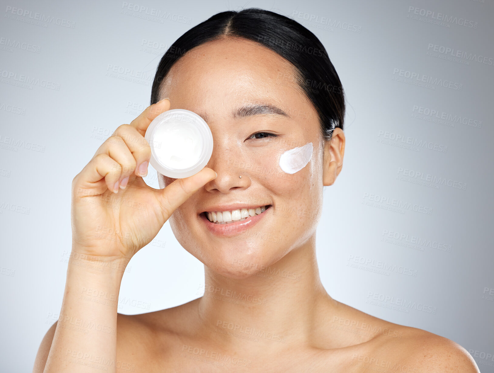 Buy stock photo Cream, eye skincare and woman with natural wellness product against grey mockup studio background. Portrait of happy asian beauty model smile with pot of facial lotion with mock up space