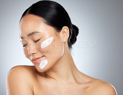 Buy stock photo Skincare, face cream and dermatology with woman posing for health, wellness and natural beauty against mockup studio background. Cosmetics, asian girl and facial for self love and makeup routine