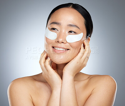 Buy stock photo Beauty, skincare and woman using eye patch, face mask or dermatology product against mockup studio background. Happy asian girl model using facial cosmetics on skin for a healthy glow with collagen