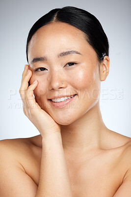 Buy stock photo Beauty, skincare and face of woman in studio for facial, grooming and cleaning against a grey background. Portrait, face and asian wellness model smile, relax and happy with cosmetics and dermatology