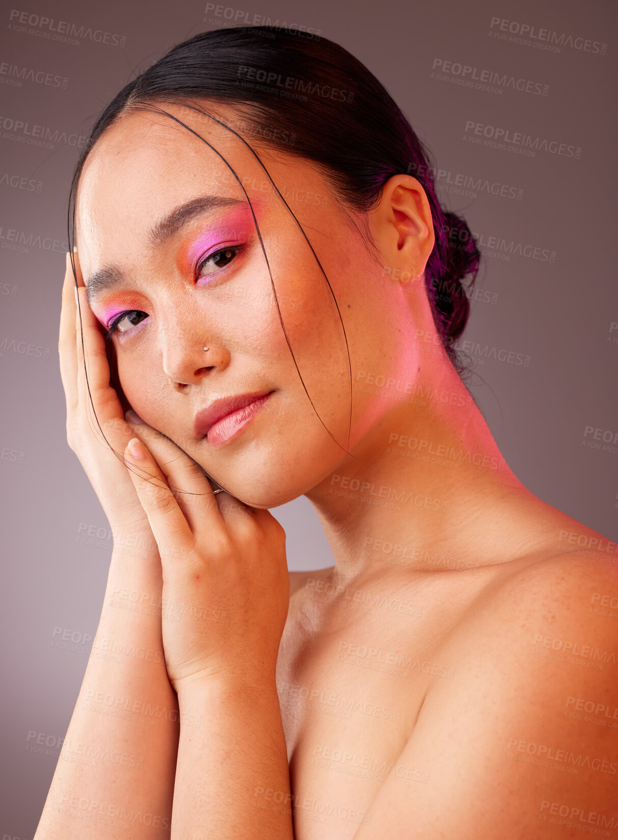 Buy stock photo Neon skincare, beauty and woman with makeup on face against a grey studio background. Portrait of calm, relax and Asian model with creative, young and facial cosmetics for art, wellness and happiness