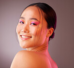 Beauty, makeup and face of model in studio with neon, creative and color vaporwave, eyeshadow and mockup. Portrait, art and Chinese model smile, happy and relax with facial cosmetics grey background