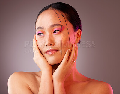 Buy stock photo Face, beauty and makeup with a model asian woman in studio on a gray background to promote cosmetics. Wellness, luxury and eye shadow with a young woman touching her skin after cosmetic treatment