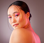 Face, eyeshadow and neon makeup of woman on gray studio background. Portrait, unique skincare or facial beauty cosmetics treatment of a beautiful female, girl or model from Japan with glowing skin.