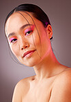 Face, makeup and beauty with a model asian woman in studio on a gray background to promote cosmetics. Portrait, natural and confident with an attractive young female posing for a cosmetic product