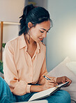 Woman, book and writing on bed for planning, dream or goal in bedroom while home. Girl, notebook and paper with smile, happy and thinking of motivation, strategy or vision for life, career or idea