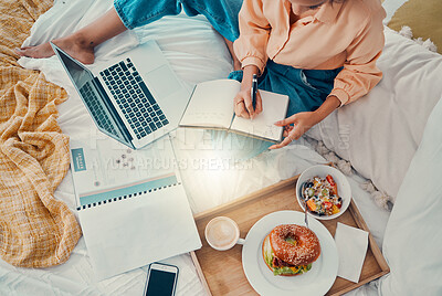 Buy stock photo Marketing, laptop and woman writing with breakfast on her bed, working and planning information for strategy from above. Remote employee with business notes, food and report for creative work on a pc