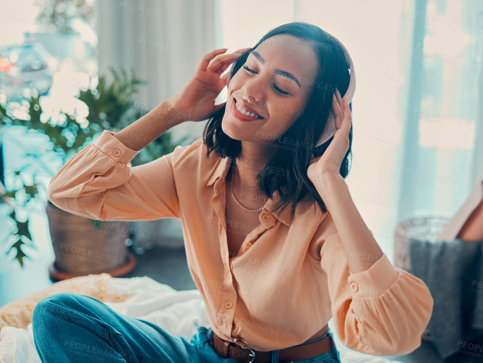 Buy stock photo Headphones, relax music and happy woman on bed in home enjoying her favorite album. Freedom, smile and carefree female from Brazil having fun streaming audio, radio or podcast sound track on headset.