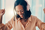 Music, dance and freedom with a woman listening to audio on headphones in her home alone. Radio, dancing and fun with an attractive young female streaming an online subscription service in her house