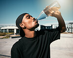 City heat, summer and black man drinking water on concrete road, thirsty gen z outdoor activity. Sun, fun and urban young man with healthy street culture lifestyle and clean water in bottle to drink.