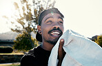 Black man, face and towel while outdoor for fitness, health and exercise in park, street or town. Man, young and gen z in summer, sunshine or trees with cloth for dry, sweat or skin in Los Angeles