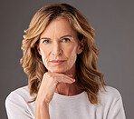 Face, beauty and skincare with a senior woman looking serious in studio on a gray background. Cosmetics, antiaging and treatment with a mature female pensior posing to promote a health product