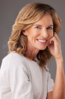 Buy stock photo Face, portrait and beauty with a senior woman in studio on a gray background to promote antiaging. Skincare, product and retirement with a mature female pensioner posing for wellness or health