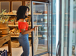 Fridge, food and woman at a supermarket shopping for grocery promotions, store sales and customer discounts deals. Smile, refrigerator and happy girl buying groceries for healthy nutrition and diet