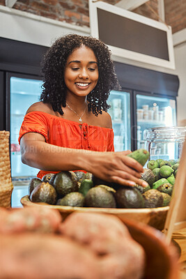 Buy stock photo Black woman at supermarket, grocery shopping and avocado, customer and retail, vegetable fresh product and buying food at store. Young, African American and smile, sale and discount on groceries.