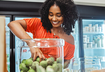 Buy stock photo Black woman, grocery store and shopping, hand in jar and fruit to buy, customer and fresh product at local supermarket. Food, retail and sale, shop organic and young African American female in store.