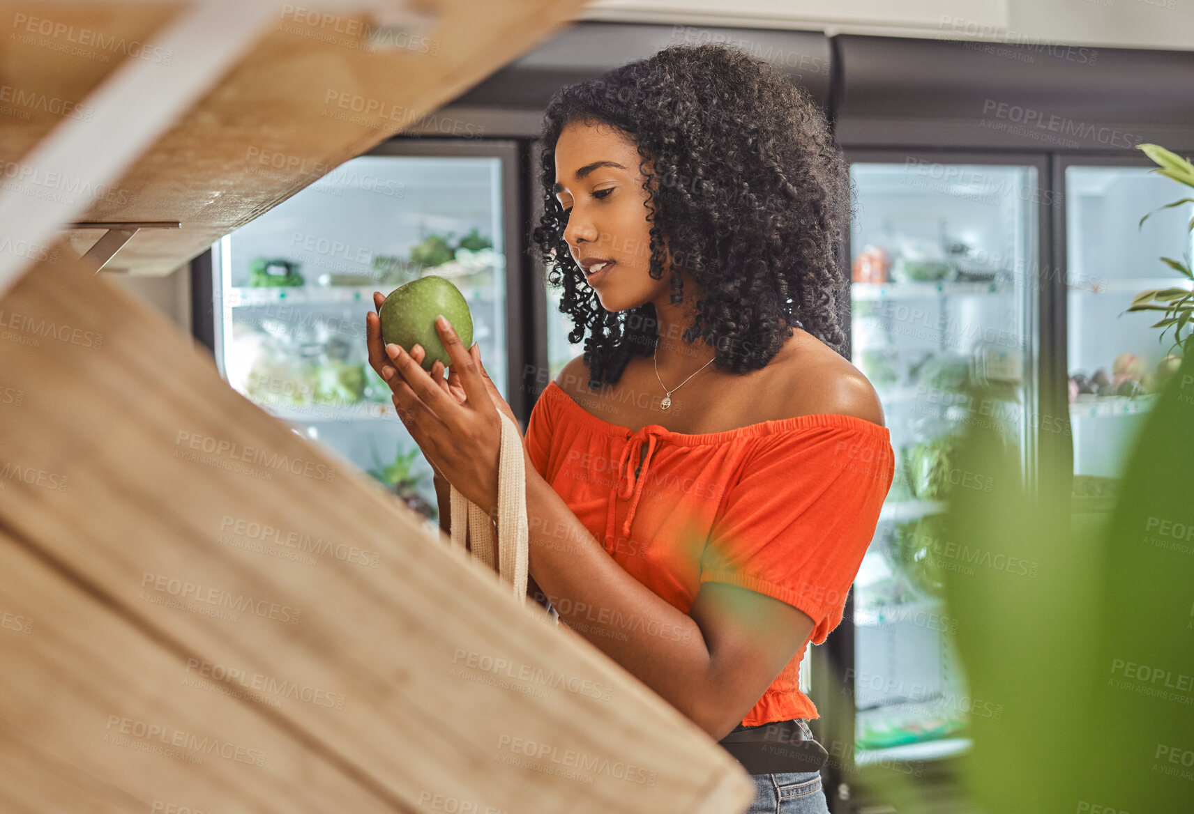 Buy stock photo Shopping, avocado and fruit at supermarket shop, buying healthy food and purchase item at a grocery store. Woman deciding, choosing and picking, fresh and delicious produce at organic farmers market
