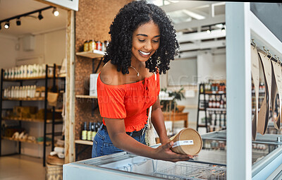 Buy stock photo Shopping, supermarket and customer with product in groceries freezer for food choice, store sale or price check. Commerce, retail and grocery of black woman in eco friendly shop happy with decision