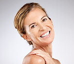 Senior, woman and skincare with smile, beauty and makeup for portrait, cosmetic or happy by studio background. Elderly, model and cosmetics for skin, face and body in dermatology, health or wellness