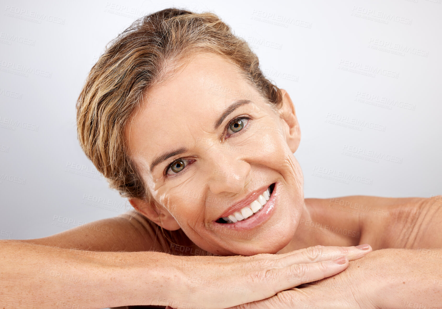 Buy stock photo Senior woman, relax and beauty for skincare with smile for cosmetics, facial or treatment against a grey studio background. Portrait of happy elderly female face relaxing and smiling for moisturizer