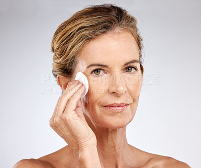 Buy stock photo Elderly skincare, beauty and facial product cleaning with cotton pad in a studio for wellness, skin and health with mockup. Portrait, face and model with senior woman wrinkles, care and treatment