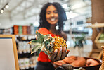 Supermarket, sustainability and shopping, woman with pineapple, buying conscious for healthy organic diet. Sustainable lifestyle to support eco friendly small business, local farm or grocery store.