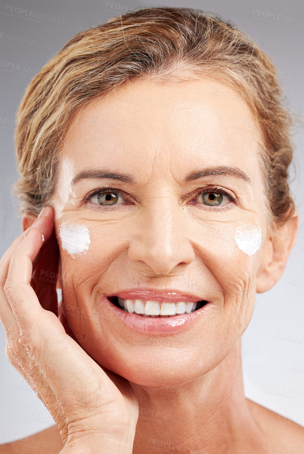 Buy stock photo Mature woman, sunscreen or face cream skincare routine on studio background in facial wellness or healthcare or sun protection. Zoom, smile or happy beauty model with spf grooming product or collagen