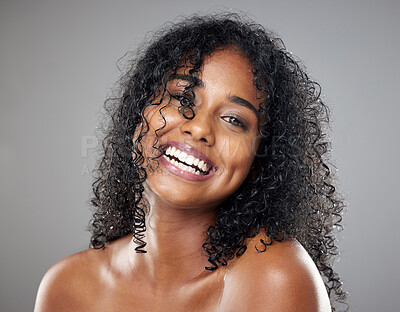 Buy stock photo Black woman, beauty and hair in face, makeup or smile against studio background with happiness. Model, hair care and happy with cosmetics for skincare, self care or portrait with glow, skin or curly