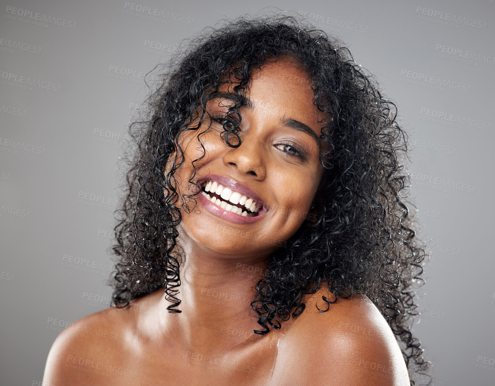Buy stock photo Black woman, beauty and hair in face, makeup or smile against studio background with happiness. Model, hair care and happy with cosmetics for skincare, self care or portrait with glow, skin or curly