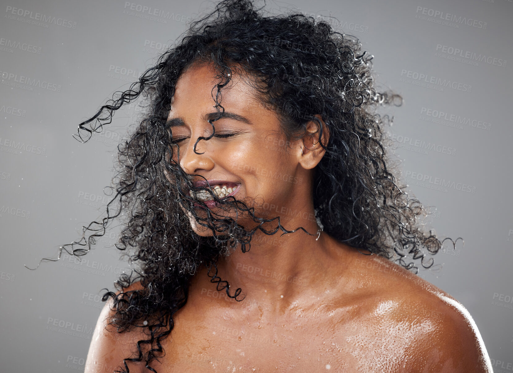 Buy stock photo Healthy, wet hair and skincare beauty of a black woman with cosmetics product mockup to hydrate, nourish and moisturize African hair. Clean skin health, cosmetics treatment and gray studio background