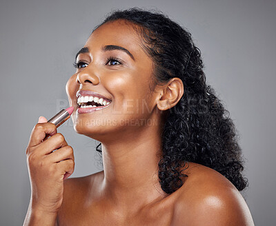 Buy stock photo Lipstick, makeup and black woman with smile, thinking and idea against a grey studio background. Happy, young and African model with cosmetics, facial care and dermatology for beauty with a glow