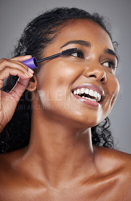 Buy stock photo Beauty, makeup and black woman in studio with mascara cosmetics, product and grooming against grey background. Face, eyes and eyelashes by happy, relax and smiling model happy with skincare treatment