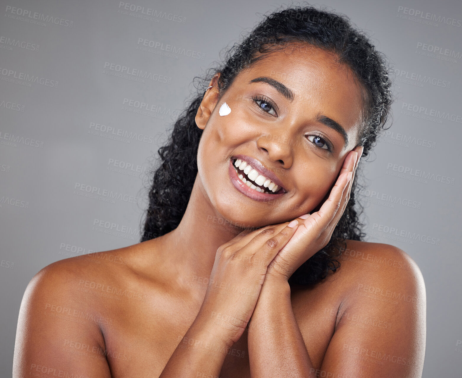 Buy stock photo Woman, skincare cream and face portrait, sunscreen makeup product and luxury beauty cosmetics for wellness on studio background. Happy indian model, facial spf lotion or natural aesthetic dermatology