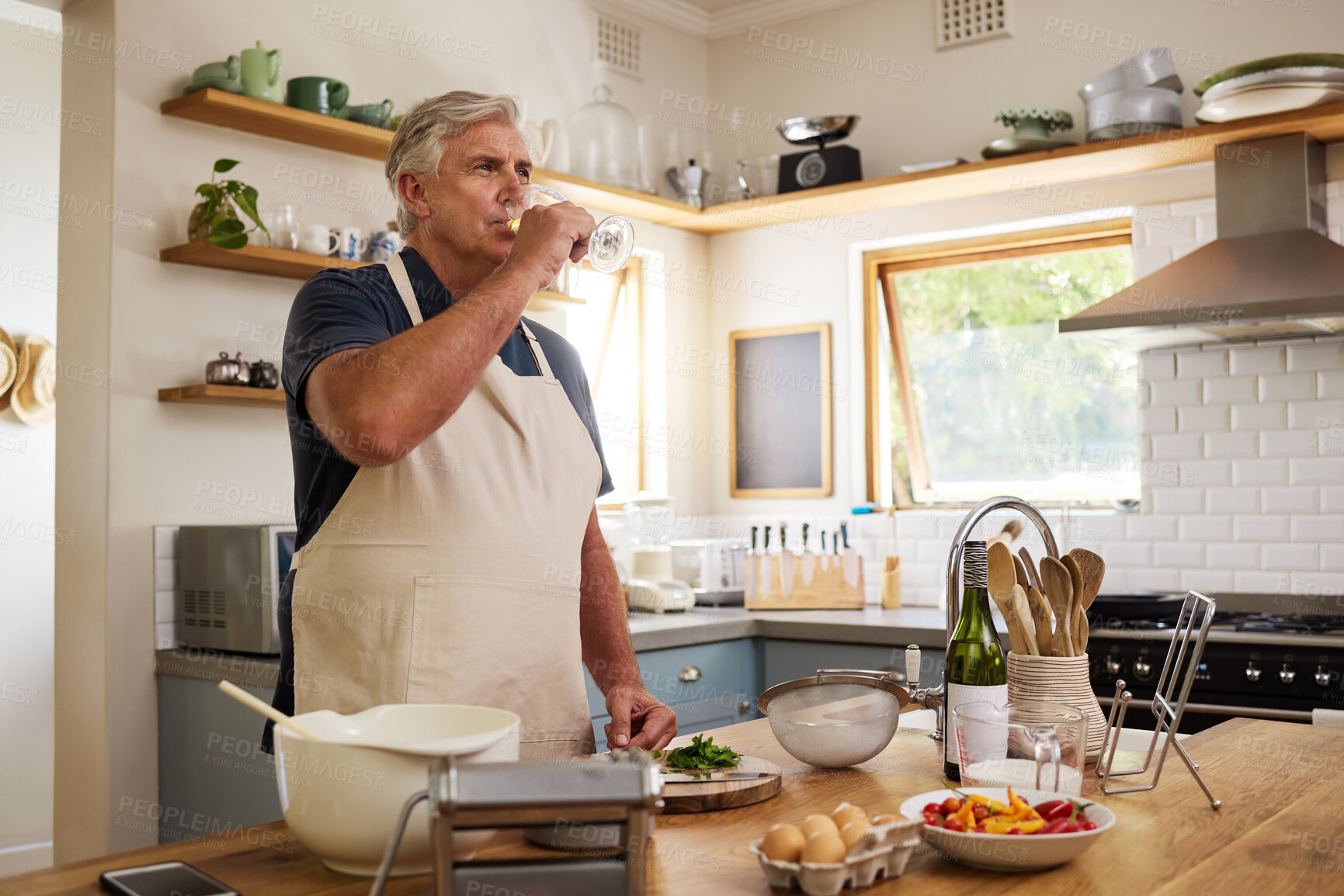 Buy stock photo Senior man, drink wine in kitchen and relax after cooking food for a healthy meal for lunch at home, happy and enjoying retirement. Elderly, retired person and baking while drinking alcohol in glass 