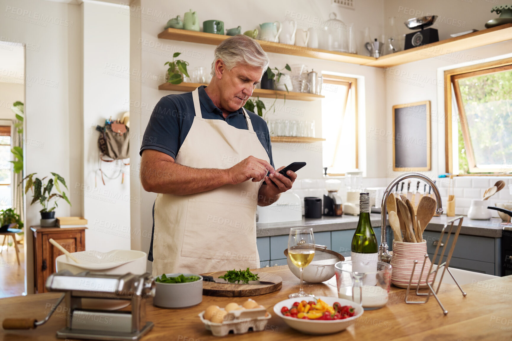 Buy stock photo Senior man, retirement and cooking in kitchen, smartphone and search internet for food recipe, technology and online connection. Healthy diet, chef skill development and research meal ideas.