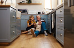 Couple, senior and wine in kitchen, floor and wood for romance, bonding or love in home for happiness. Elderly, man and woman make toast, happy or smile for glass, drinking and together on flooring