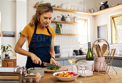 Buy stock photo Mature woman, cooking and cutting salad leaf in house and home kitchen for wellness food, health diet and lunch meal. Chef, nutritionist and person with cuisine knife for vegetables or dinner recipe
